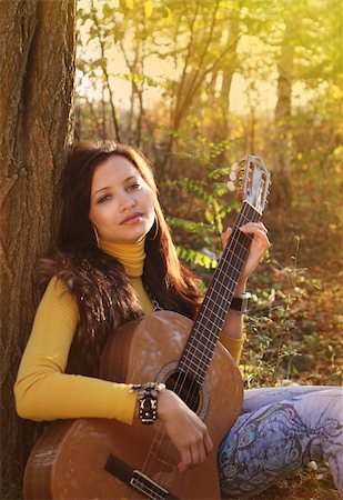 Beautiful brunette guitar player girl in the forest Stock Photo - Budget Royalty-Free & Subscription, Code: 400-05881533