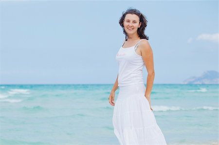 simsearch:400-04643781,k - Handsome young woman walking near blue sea. Stock Photo - Budget Royalty-Free & Subscription, Code: 400-05882079