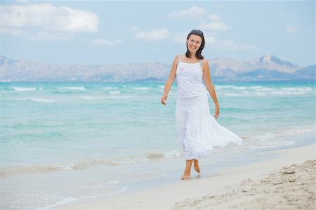 simsearch:400-04643781,k - Handsome young woman walking near blue sea. Stock Photo - Budget Royalty-Free & Subscription, Code: 400-05882080