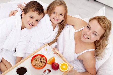 Breakfast in bed for mom-kids pampering their mother Stock Photo - Budget Royalty-Free & Subscription, Code: 400-05882461