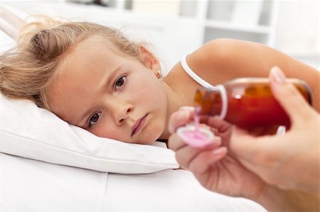 Sick little girl with flu awaiting medication- focus on the eyes Foto de stock - Super Valor sin royalties y Suscripción, Código: 400-05882503