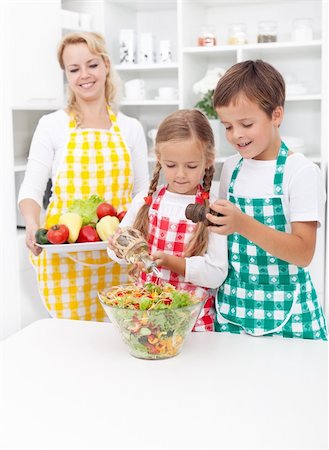 food salt kids - Kids preparing and seasoning a healthy fresh salad in the kitchen Stock Photo - Budget Royalty-Free & Subscription, Code: 400-05882538
