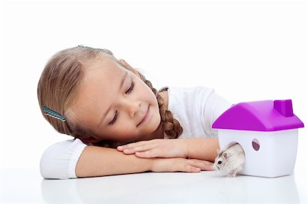 Little girl watching her hamster crawling out of plastic house Stock Photo - Budget Royalty-Free & Subscription, Code: 400-05882559