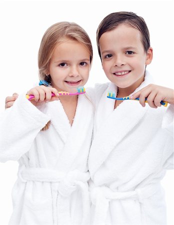 Beautiful kids preparing to brush their teeth wearing white bathrobes - isolated, closeup Stock Photo - Budget Royalty-Free & Subscription, Code: 400-05882578