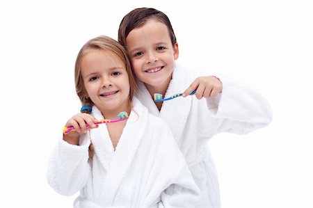 Happy and clean kids washing teeth wearing batrobes - isolated Stock Photo - Budget Royalty-Free & Subscription, Code: 400-05882579