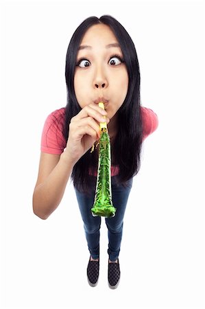 party streamers on white background - A wide angle shot of an Asian girl blowing a noise maker. Stock Photo - Budget Royalty-Free & Subscription, Code: 400-05882616