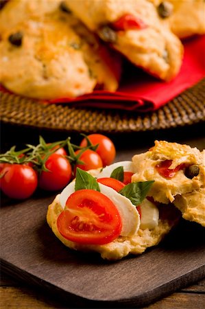 delicious homemade pizza rolls stuffed with tomatoe and mozzarella on wooden table Stock Photo - Budget Royalty-Free & Subscription, Code: 400-05882653