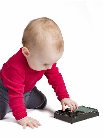young child in white background with hard drive. red shirt and blue trousers Photographie de stock - Aubaine LD & Abonnement, Code: 400-05882716