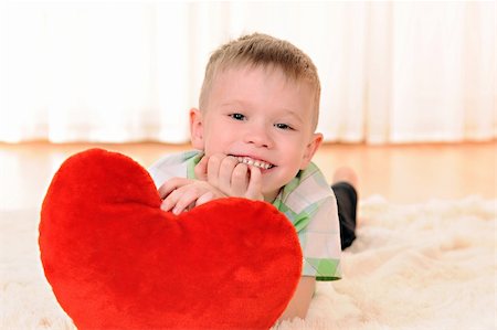 red carpet fun - the child is lie on the floor with a red plush heart Stock Photo - Budget Royalty-Free & Subscription, Code: 400-05882751