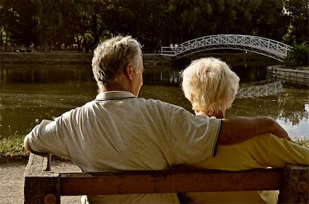 Senior couple relaxing, sitting on a bench by a small fishing lake in a leisure park, enjoying the afternoon sunlight. Stock Photo - Budget Royalty-Free & Subscription, Code: 400-05882801