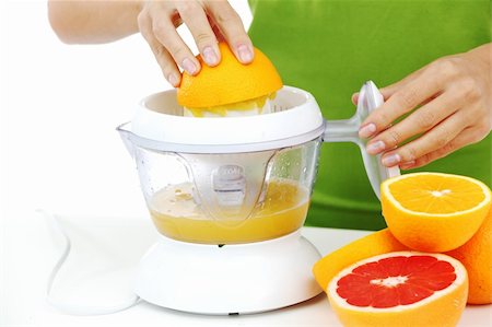 summer and pressure - woman squeezes juice by juicer Stock Photo - Budget Royalty-Free & Subscription, Code: 400-05882975