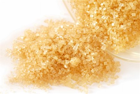 heap of yellowish brown sugar over white background Stock Photo - Budget Royalty-Free & Subscription, Code: 400-05883333