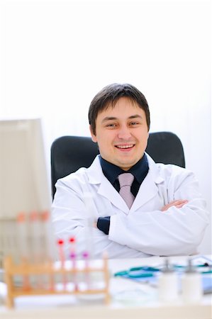 simsearch:400-07099889,k - Portrait of smiling medical doctor sitting in cabinet Stock Photo - Budget Royalty-Free & Subscription, Code: 400-05883621