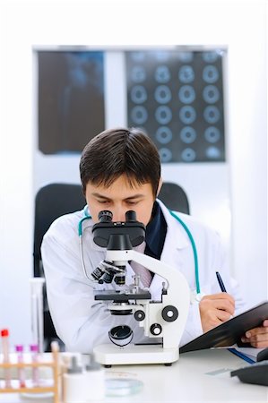 simsearch:400-04925813,k - Researcher using microscope in medical laboratory Stock Photo - Budget Royalty-Free & Subscription, Code: 400-05883638