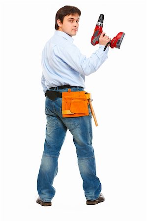 Full length portrait of construction worker with drill look back Stock Photo - Budget Royalty-Free & Subscription, Code: 400-05883681