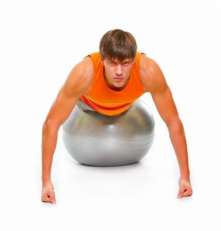 Young man in sportswear making push up exercise on fitness ball isolated on white Stock Photo - Budget Royalty-Free & Subscription, Code: 400-05883700