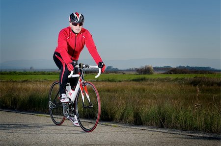 simsearch:400-04744671,k - Man on road bike on open country road background. Photographie de stock - Aubaine LD & Abonnement, Code: 400-05894122