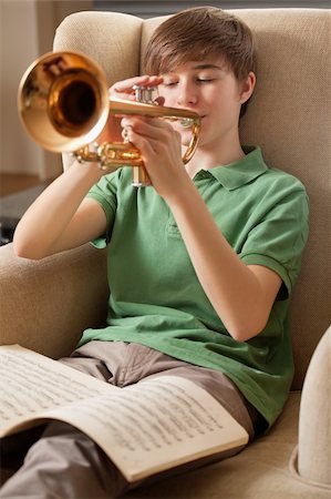 people playing brass instruments - Photo of a teenage male practicing his trumpet at home. Focus on face of boy. Stock Photo - Budget Royalty-Free & Subscription, Code: 400-05894254