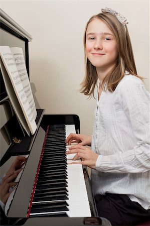 piano practice - Photo of a young girl playing the piano at home. Stock Photo - Budget Royalty-Free & Subscription, Code: 400-05894253