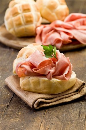 delicious sandwich on wooden table with mortadella sausage Stockbilder - Microstock & Abonnement, Bildnummer: 400-05894498