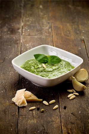 fresh pesto sauce inside a bowl on wooden table Stockbilder - Microstock & Abonnement, Bildnummer: 400-05894502