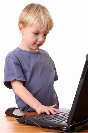 simsearch:400-04129482,k - Portrait of a young boy working on a laptop computer Photographie de stock - Aubaine LD & Abonnement, Code: 400-05894544