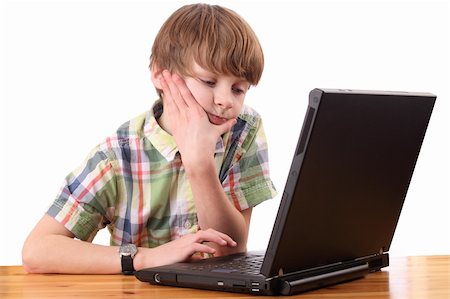 Portrait of a tired and upset boy working on a laptop computer Stock Photo - Budget Royalty-Free & Subscription, Code: 400-05894549