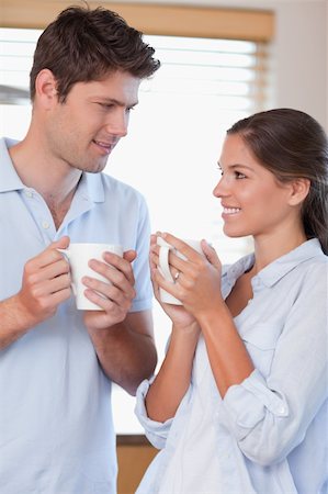 simsearch:400-04335902,k - Portrait of a happy couple drinking coffee in their kitchen Photographie de stock - Aubaine LD & Abonnement, Code: 400-05894654