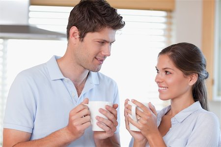 simsearch:400-04335902,k - Happy couple drinking tea while looking at each other Photographie de stock - Aubaine LD & Abonnement, Code: 400-05894651