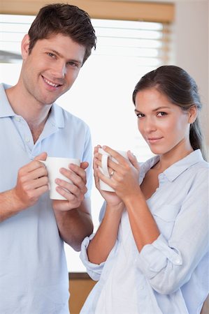 simsearch:400-04335902,k - Portrait of a couple drinking tea in their kitchen Stock Photo - Budget Royalty-Free & Subscription, Code: 400-05894652