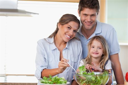 simsearch:400-04206231,k - Smiling family preparing a salad in their kitchen Stock Photo - Budget Royalty-Free & Subscription, Code: 400-05894668