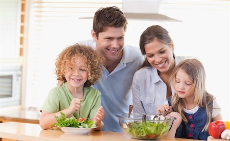 simsearch:400-04206231,k - Happy family preparing a salad together in their kitchen Stock Photo - Budget Royalty-Free & Subscription, Code: 400-05894676