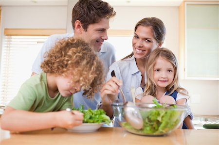 simsearch:695-03384582,k - Happy family preparing a salad in their kitchen Stock Photo - Budget Royalty-Free & Subscription, Code: 400-05894673
