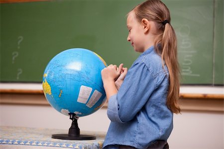 Schoolgirl looking at a globe in a classroom Stock Photo - Budget Royalty-Free & Subscription, Code: 400-05894758