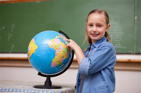 simsearch:400-05895060,k - Smiling schoolgirl looking at a globe in a classroom Photographie de stock - Aubaine LD & Abonnement, Code: 400-05894760