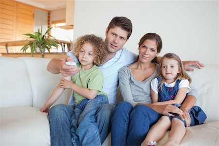 simsearch:6109-06003128,k - Family watching TV together in their living room Stock Photo - Budget Royalty-Free & Subscription, Code: 400-05894779