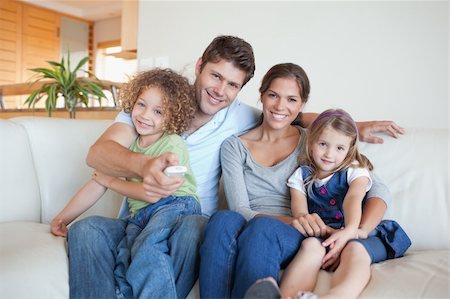 simsearch:6109-06003128,k - Happy family watching TV together in their living room Stock Photo - Budget Royalty-Free & Subscription, Code: 400-05894780