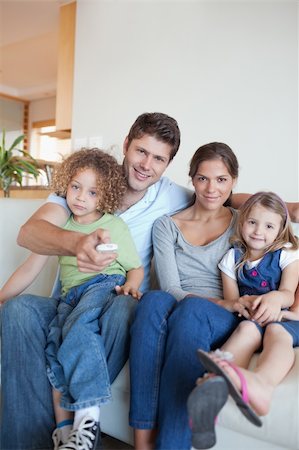 simsearch:6109-06003128,k - Portrait of a family watching TV together in their living room Stock Photo - Budget Royalty-Free & Subscription, Code: 400-05894781