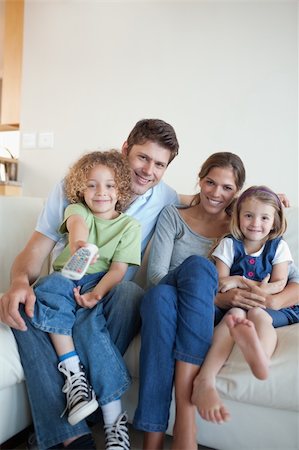 simsearch:6109-06003128,k - Portrait of a happy family watching TV together in their living room Stock Photo - Budget Royalty-Free & Subscription, Code: 400-05894783