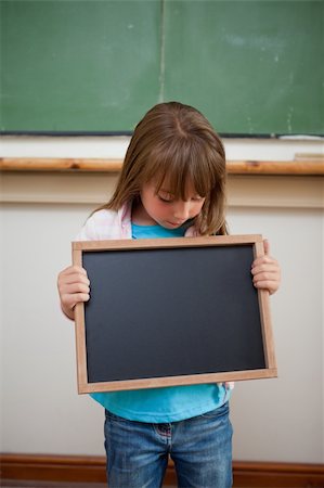 Portrait of a girl looking at a school slate in a classroom Stock Photo - Budget Royalty-Free & Subscription, Code: 400-05895118