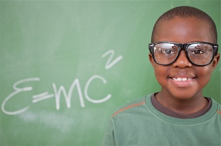 Smart schoolboy posing in front of a blackboard Stock Photo - Budget Royalty-Free & Subscription, Code: 400-05895199