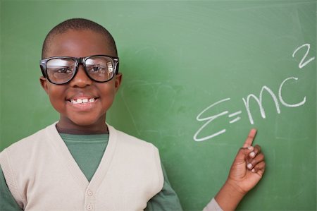 Smart schoolboy showing the the mass-energy equivalence formula on a blackboard Stock Photo - Budget Royalty-Free & Subscription, Code: 400-05895210