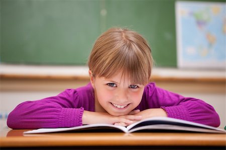 Schoolgirl leaning on a desk in a classroom Stock Photo - Budget Royalty-Free & Subscription, Code: 400-05895408