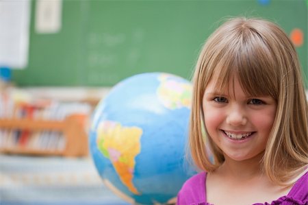 simsearch:400-05895060,k - Schoolgirl posing in front of a globe in a classroom Photographie de stock - Aubaine LD & Abonnement, Code: 400-05895400