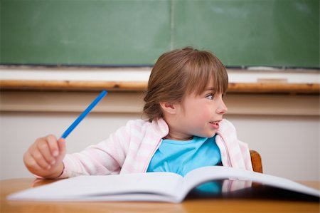 simsearch:400-05329645,k - Happy girl holding a pen in a classroom Stock Photo - Budget Royalty-Free & Subscription, Code: 400-05895499