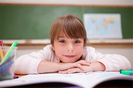 simsearch:400-06744675,k - Smiling schoolgirl leaning on a desk in a classroom Stock Photo - Budget Royalty-Free & Subscription, Code: 400-05895490