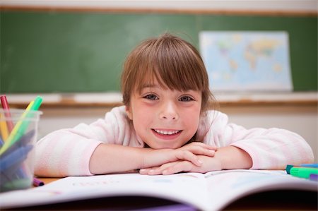 simsearch:400-06744675,k - Happy schoolgirl leaning on a desk in classroom Stock Photo - Budget Royalty-Free & Subscription, Code: 400-05895491