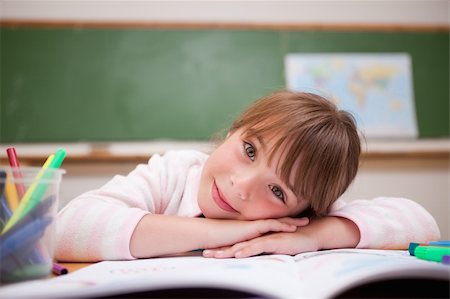 simsearch:400-06744675,k - Cute schoolgirl leaning on a desk in a classroom Stock Photo - Budget Royalty-Free & Subscription, Code: 400-05895493