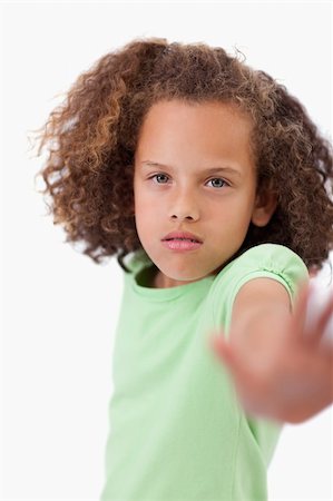 simsearch:400-06635276,k - Portrait of a girl saying stop with her hand against white background Photographie de stock - Aubaine LD & Abonnement, Code: 400-05895605