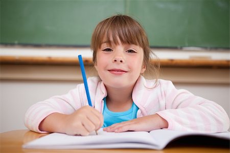 simsearch:400-05329645,k - Happy girl writing in a classroom Stock Photo - Budget Royalty-Free & Subscription, Code: 400-05895614